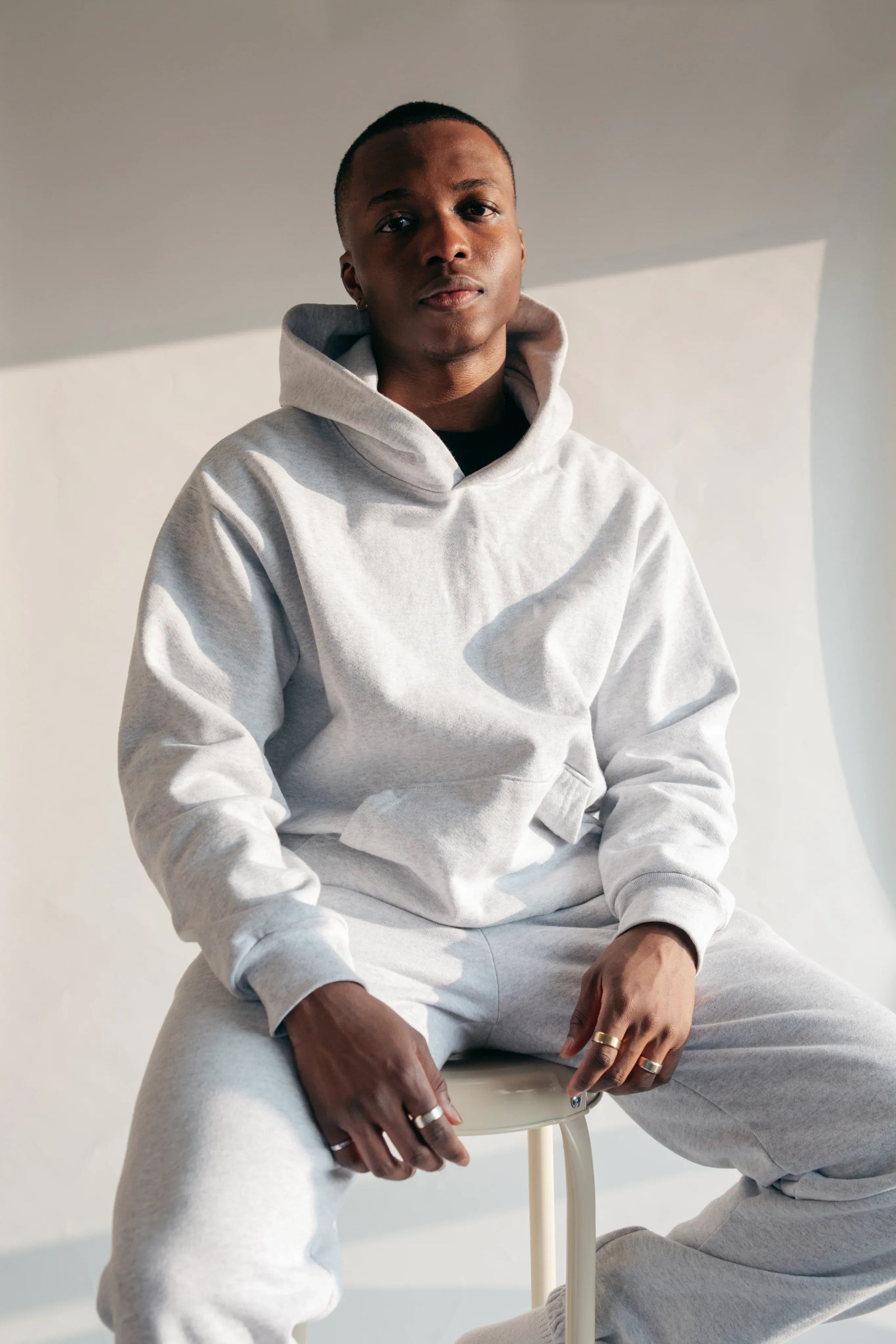 man-on-stool-in-hoodie-and-sweatpants - SHIRT & CANVAS